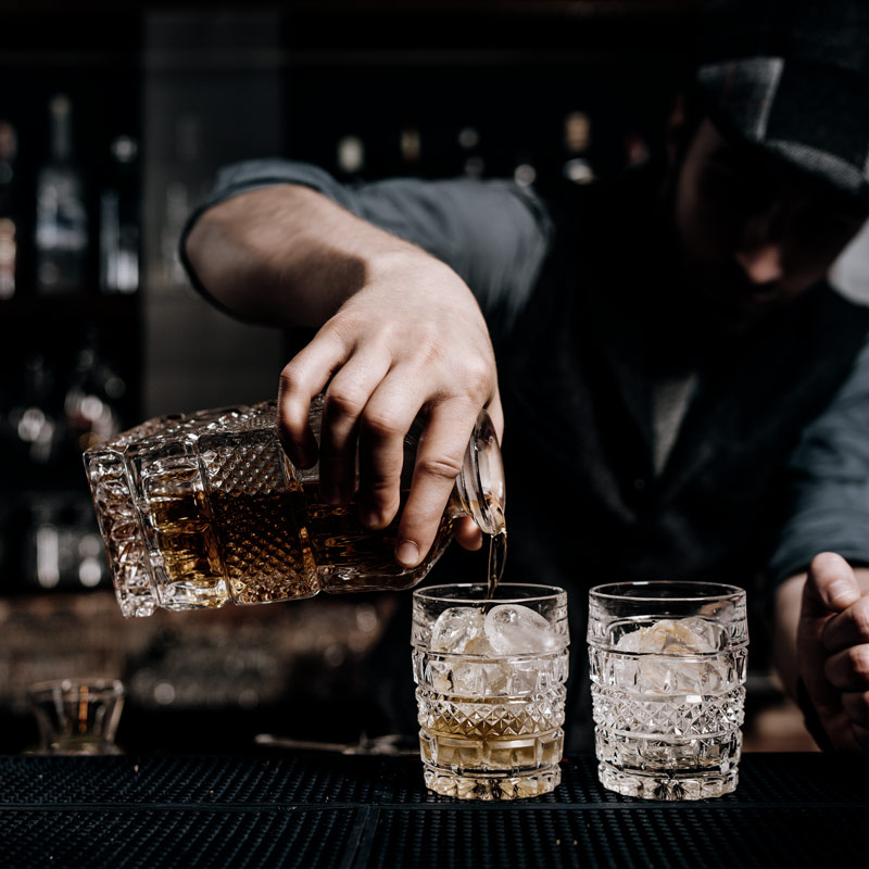 man pouring whiskey at the pressroom